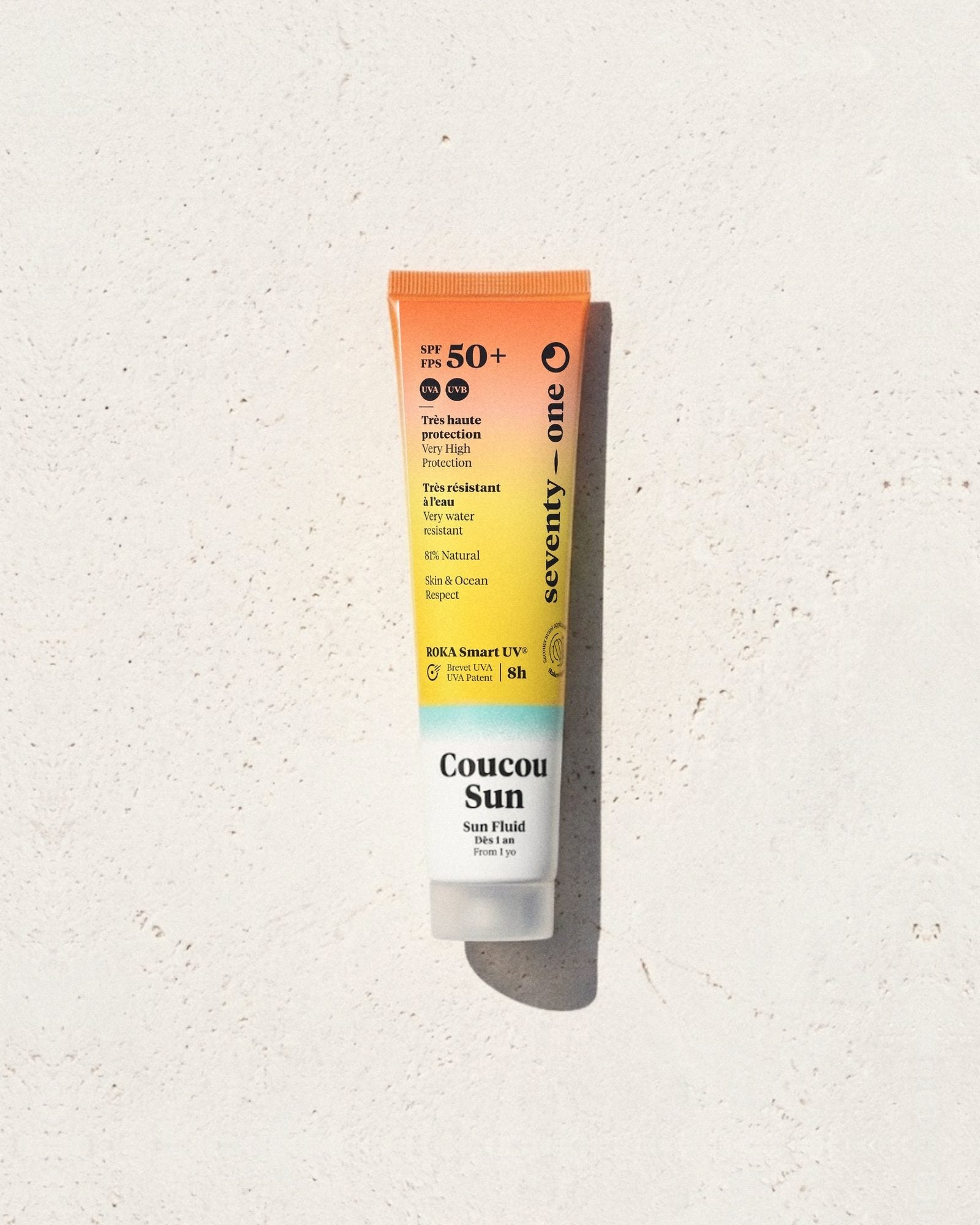 Coucou Sun SPF 50+ SeventyOne Percent, fluide solaire très haute protection dès 1 an 40 ml, tube posé sur une pierre blanche au soleil