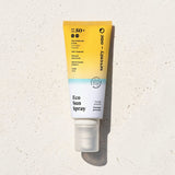 EcoSun Spray SPF 50+ SeventyOne Percent, protection solaire minérale corps 100 ml, flacon posé sur une pierre blanche au soleil